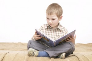 little boy reading a book