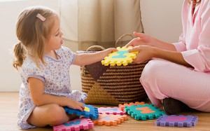 Mother and daughter playing with alphabet toy